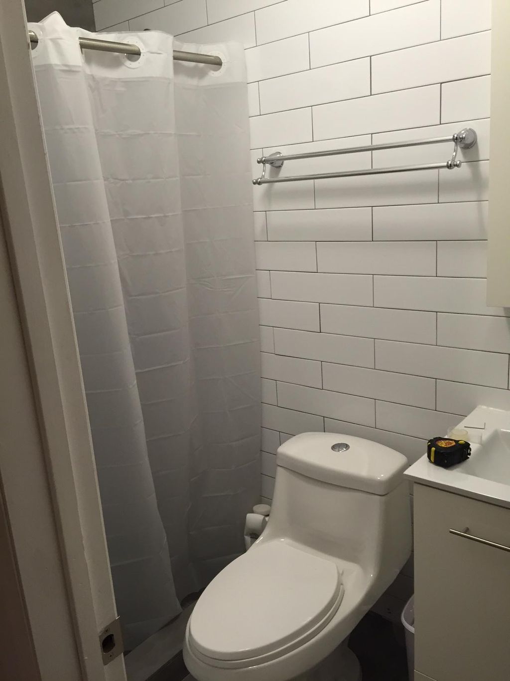 Installed towel racks, TP roll
 and shower curtain