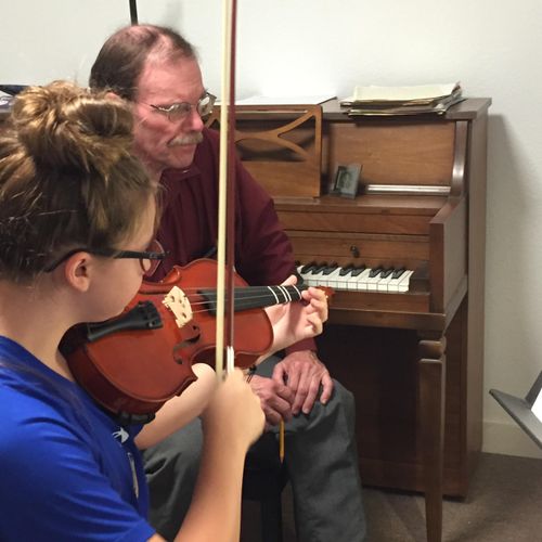 Violin student Kendall C. works with Teacher Mike 