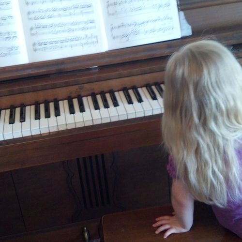 Our youngest student at her favorite piano.