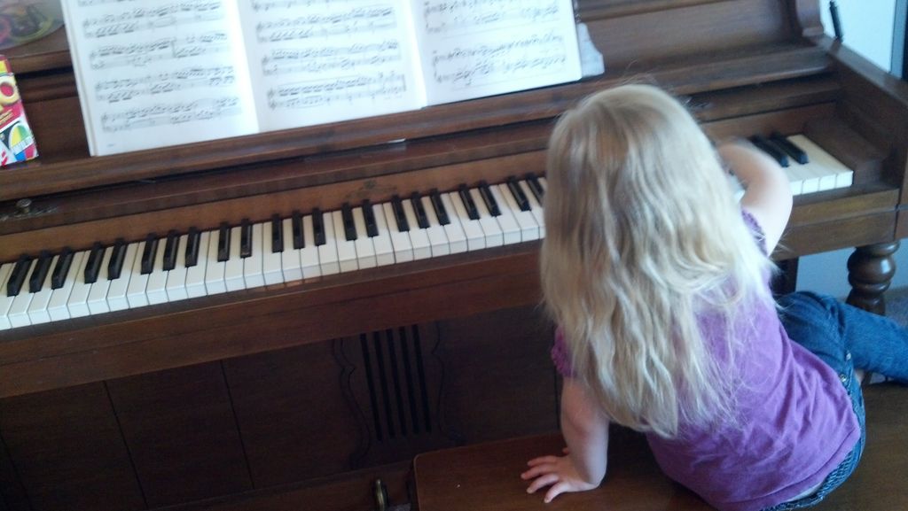 Our youngest student at her favorite piano.