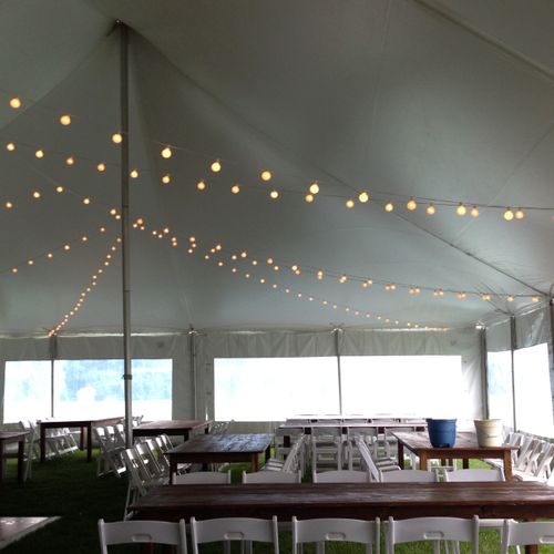 bistro lights and farm tables with white garden ch
