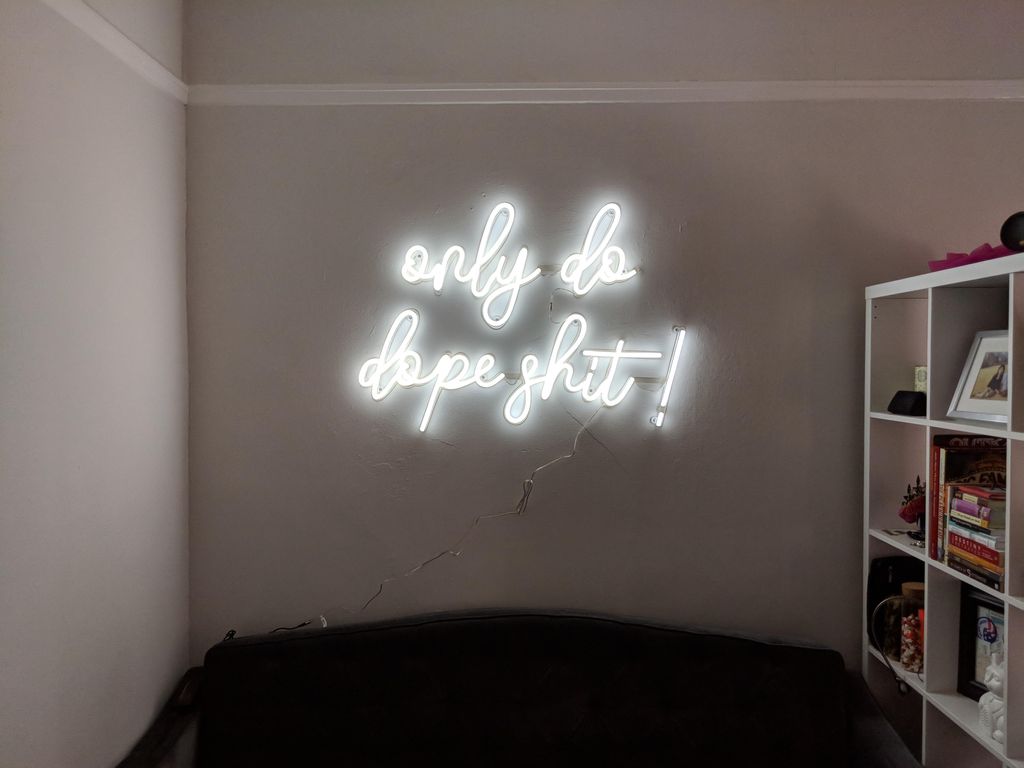 mounted neon sign to living room wall
