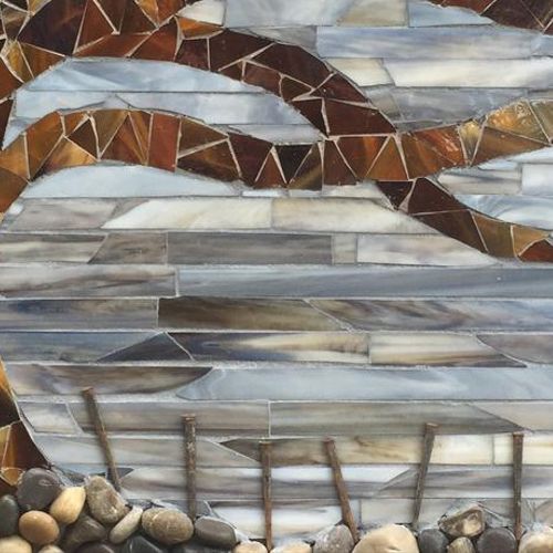 Mosaic from stained glass, rocks and reclaimed flo