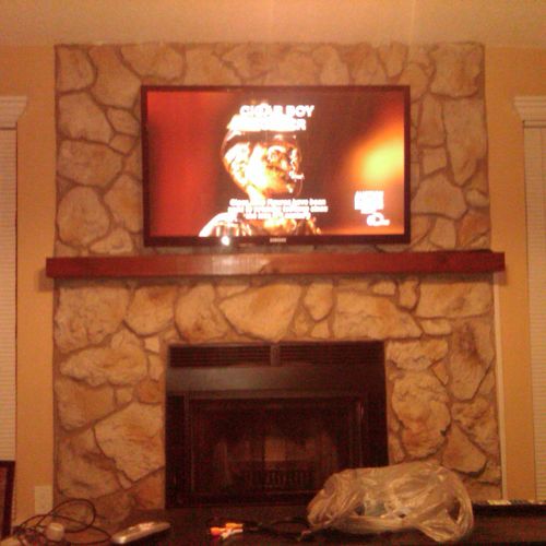 This TV was mounted on a Faux stone fireplace. Une