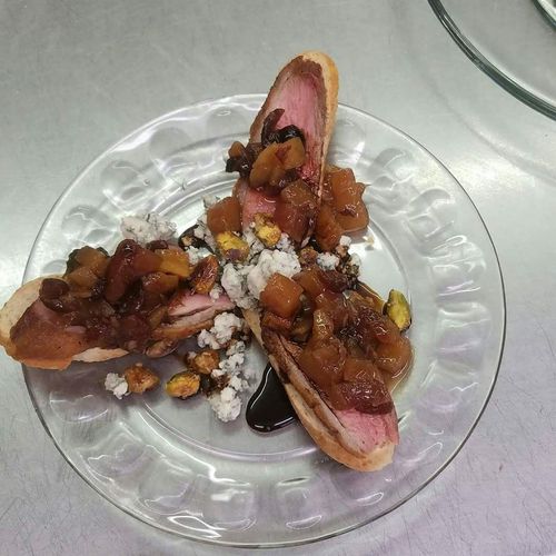 sliced duck breast on crostini with apple ginger c