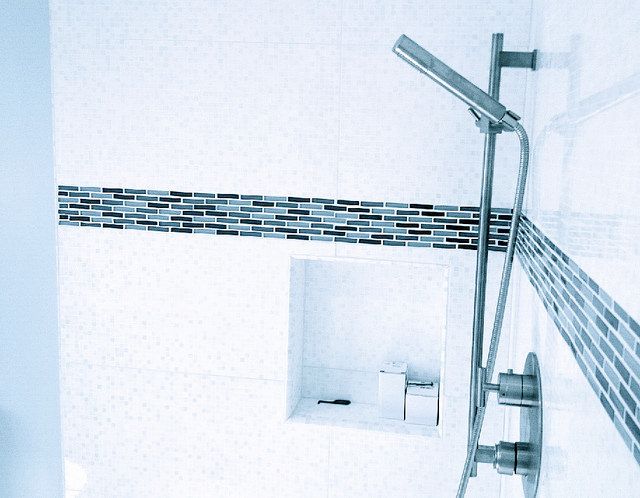 Porcelain tile shower installation with glass tile