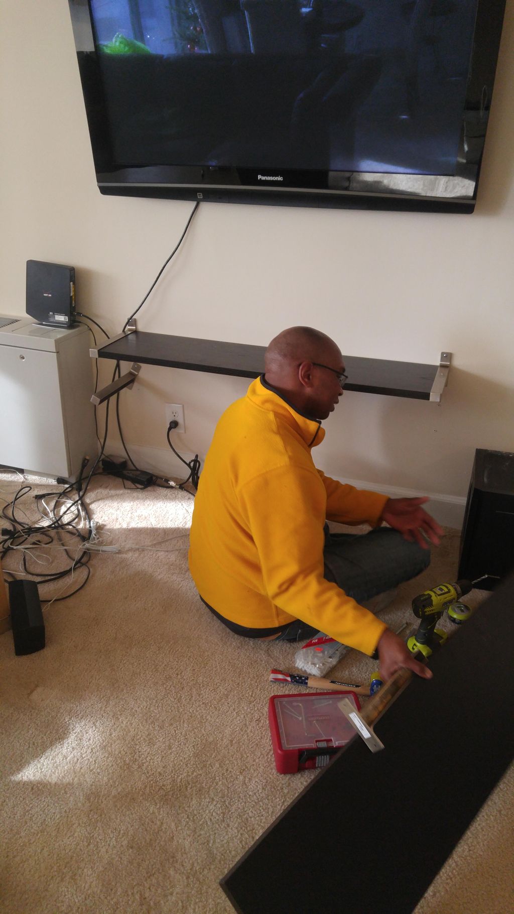 setting up shelves after hanging tv