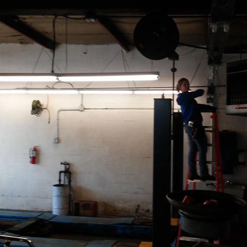 Adding lights in a commercial garage.