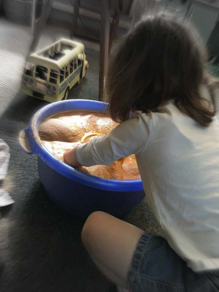  This child has flooded sand with water and sunk h