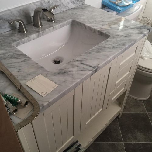 Freestanding vanity, granite countertop and sink. 