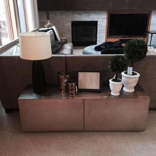 Low console behind the sofa in a contemporary cham