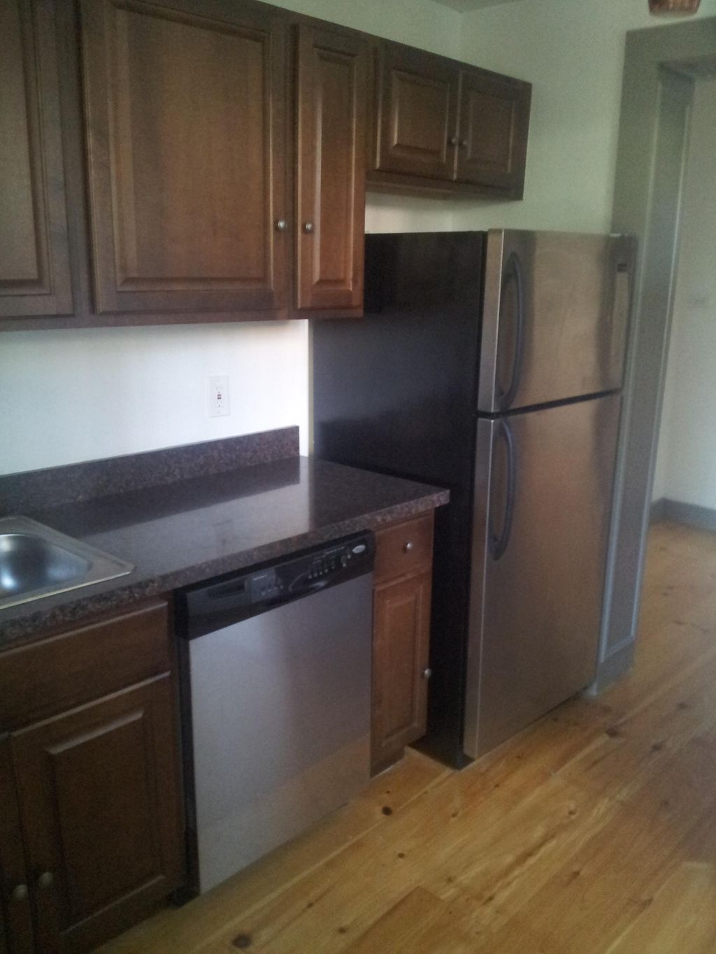 updated rental kitchen with solid plank pine floor