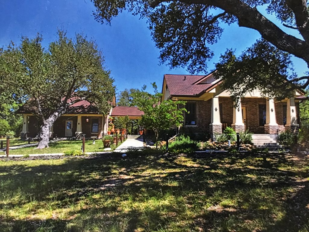 Front view of House w/Guest House and covered pati