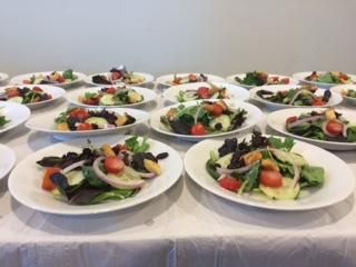 plated salads being prepped for a wedding July 201