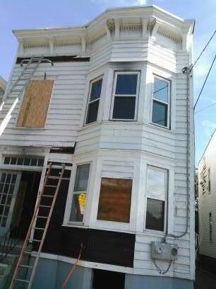 the start of removing old wood siding from the fro