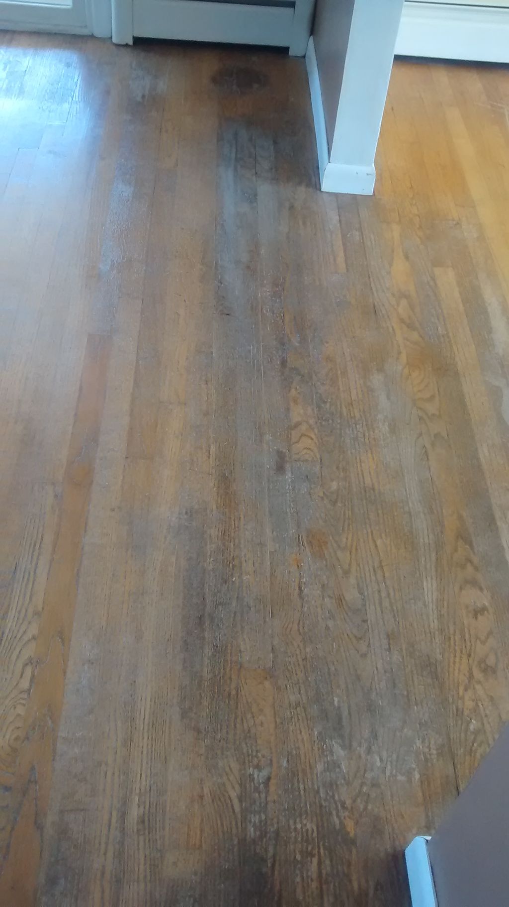 Heavily damaged hardwood flooring