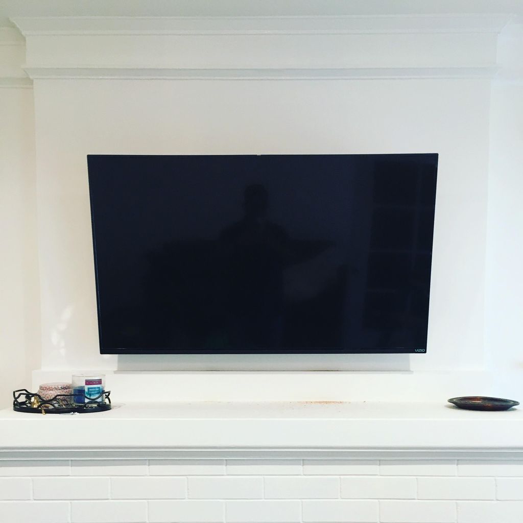 Mounted tv on top of fireplace 