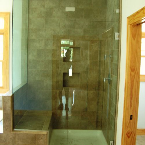 Custom shower, tile and glass shower door and surr