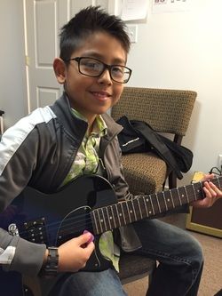 Guitar student Aaron shows off his skill