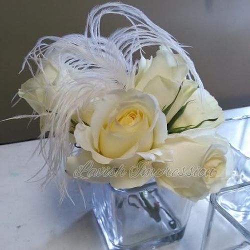 simple creamy and white roses  with ostrich feathe