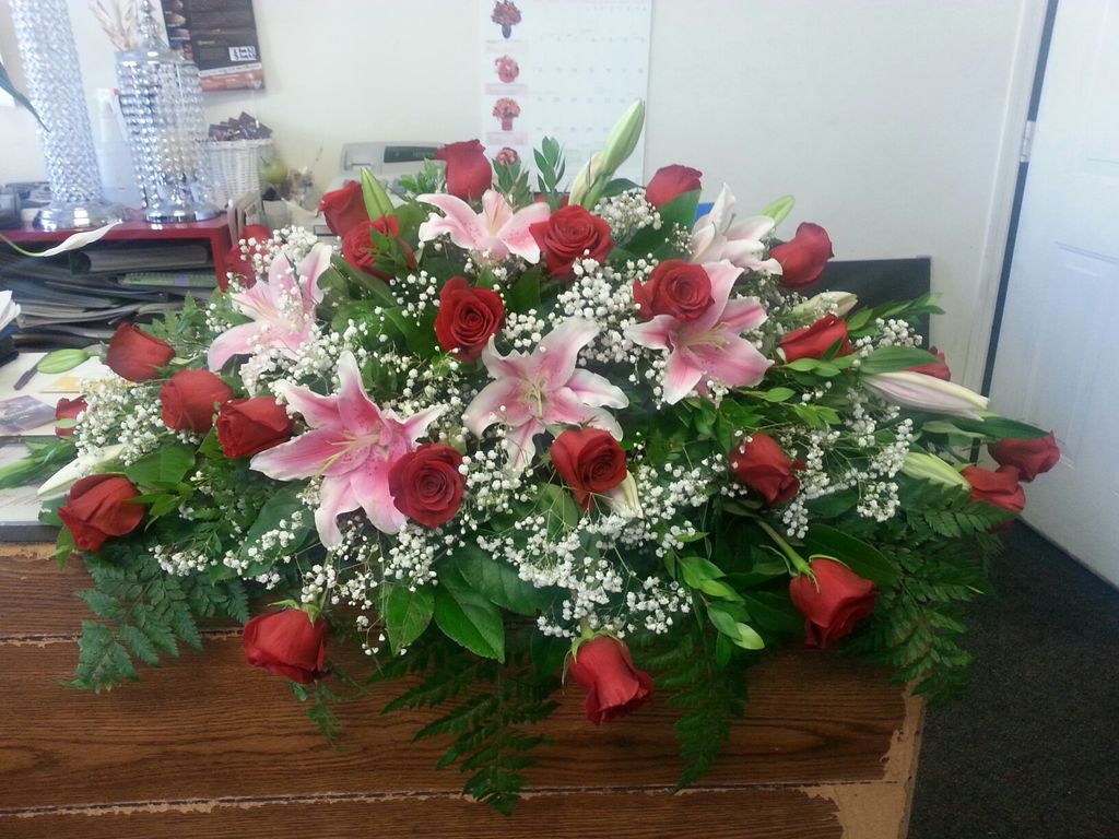 Roses and Lilies casket piece for a funeral.