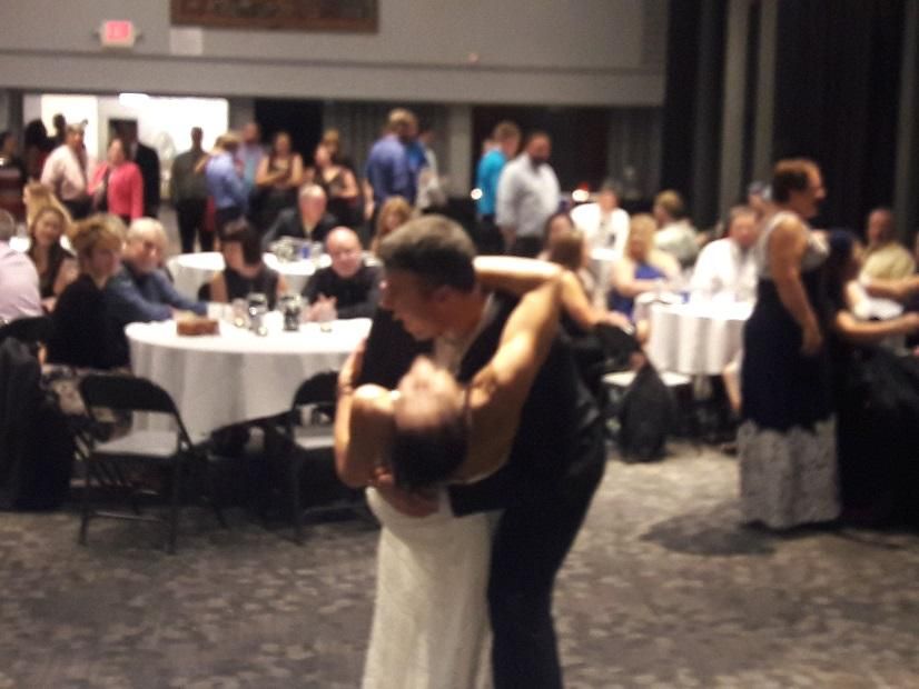Husband dips his bride during their first dance