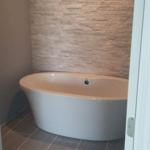 bath tub unstalled as well as a brick surround and