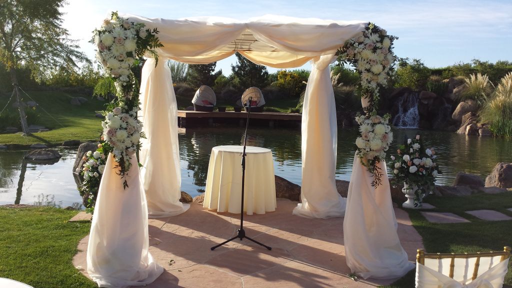 Fresh blush roses accent this ivory chuppah.