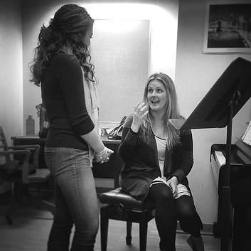 Katie works with a singer in a private voice lesso
