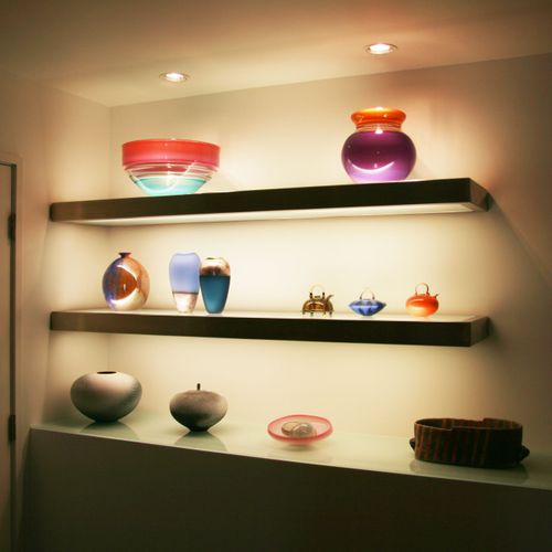 Lighted glass and stainless steel display shelves.