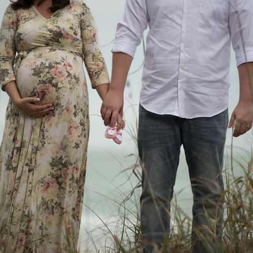 Maternity shoot for a couple taken on the beach in