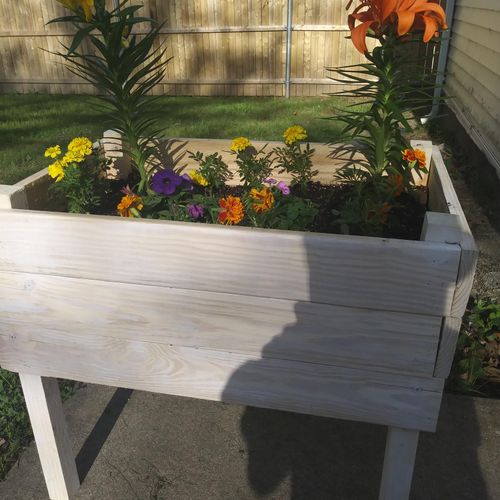 Custom raised flower bed made from repurposed wood