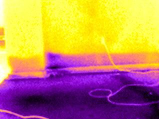 Infrared photo showing, cooler, wet area of wall.
