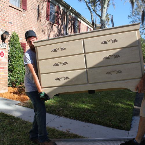 Brian and Mike bringing a dresser down.