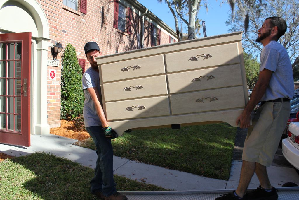 Brian and Mike bringing a dresser down.