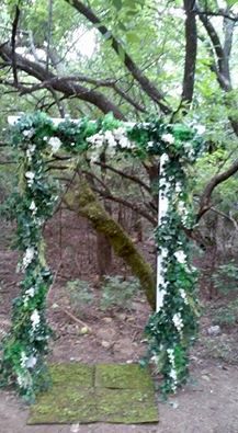 Arbor covered in Ivy and mixed greens with white s