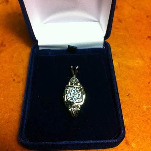 Custom topaz and diamond pendant made from women's
