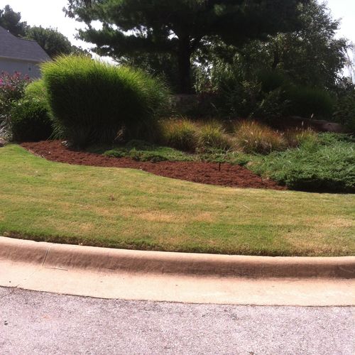 Fresh mulch helps retain water and keeps the soil 
