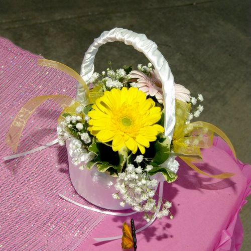 Flower girl bouquet made of daisies with butterfli