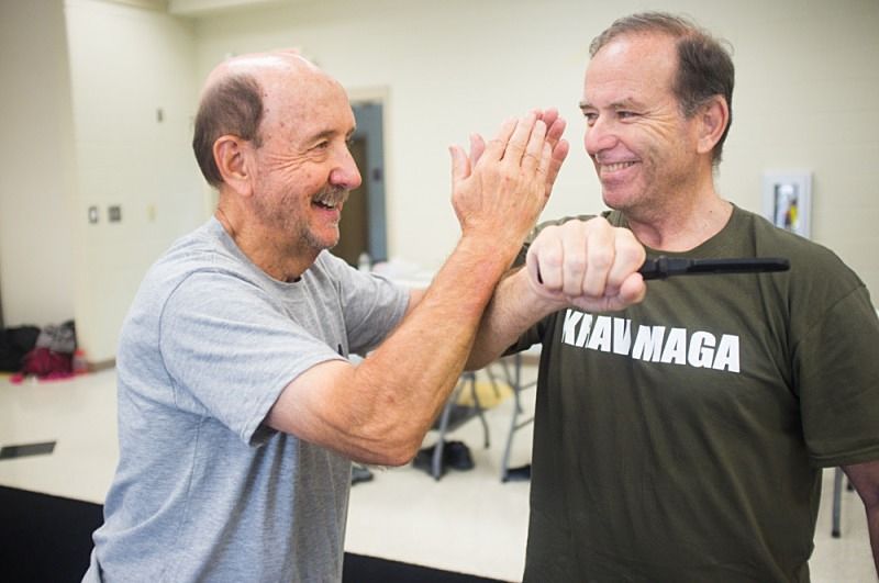 Helping a student learn how to block a knife attac