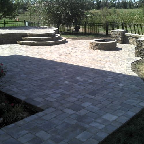 Firepit, seat wall, two tiered patio, and plantings