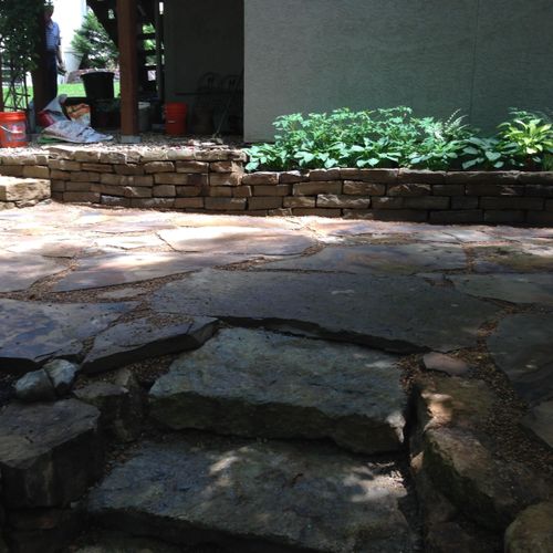 Slate patio with Kansas boulders used for retainin