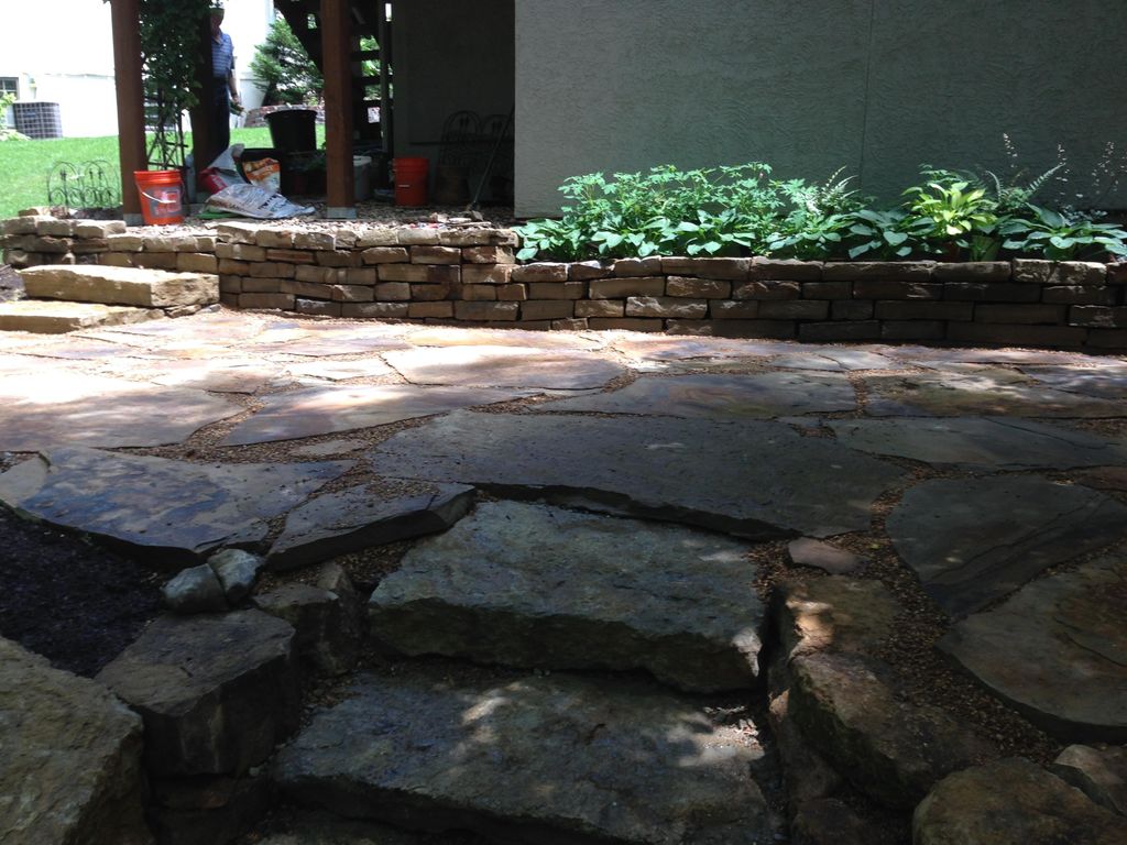 Slate patio with Kansas boulders used for retainin