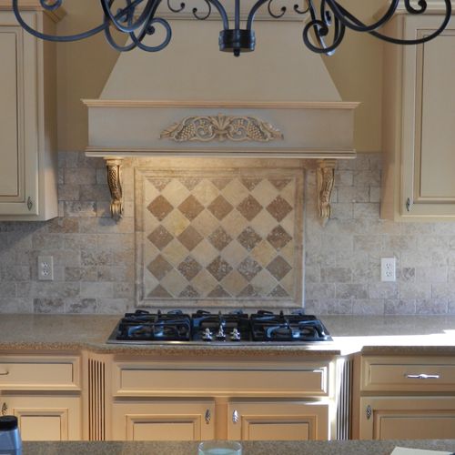 New tile backsplash with design above stove