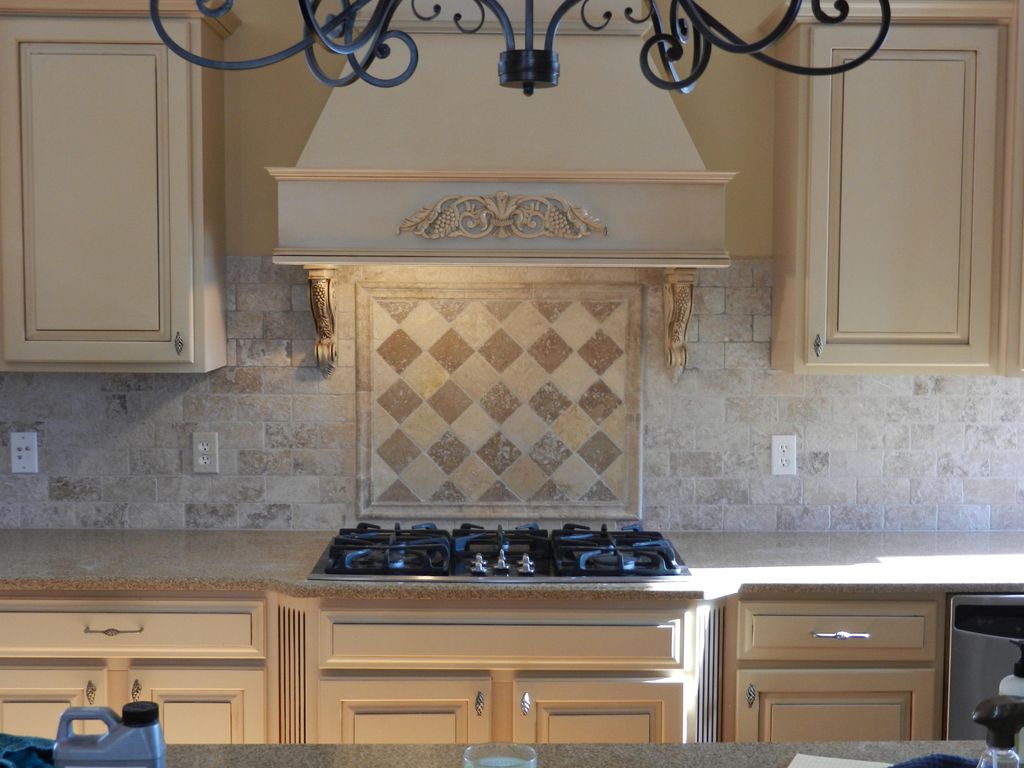 New tile backsplash with design above stove