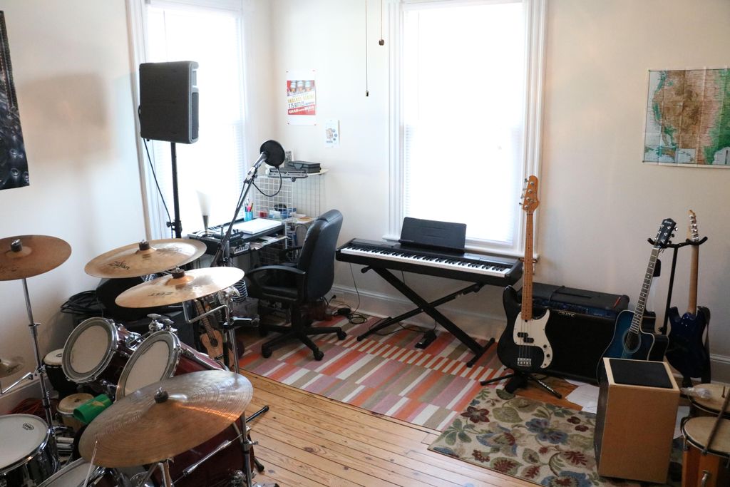 Home studio featuring a variety instruments to ins