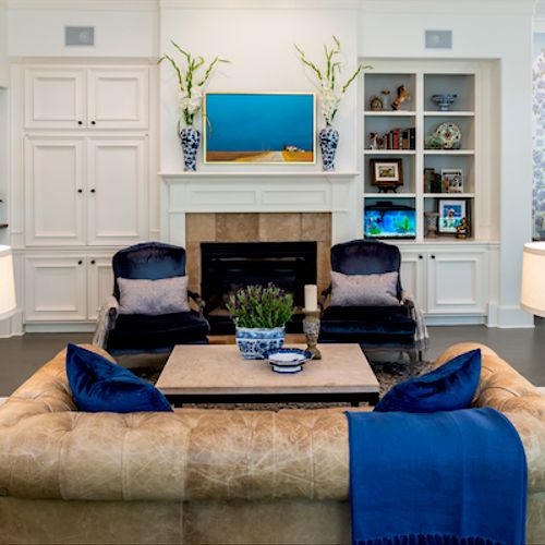 Traditional blue velvet chairs and leather chester