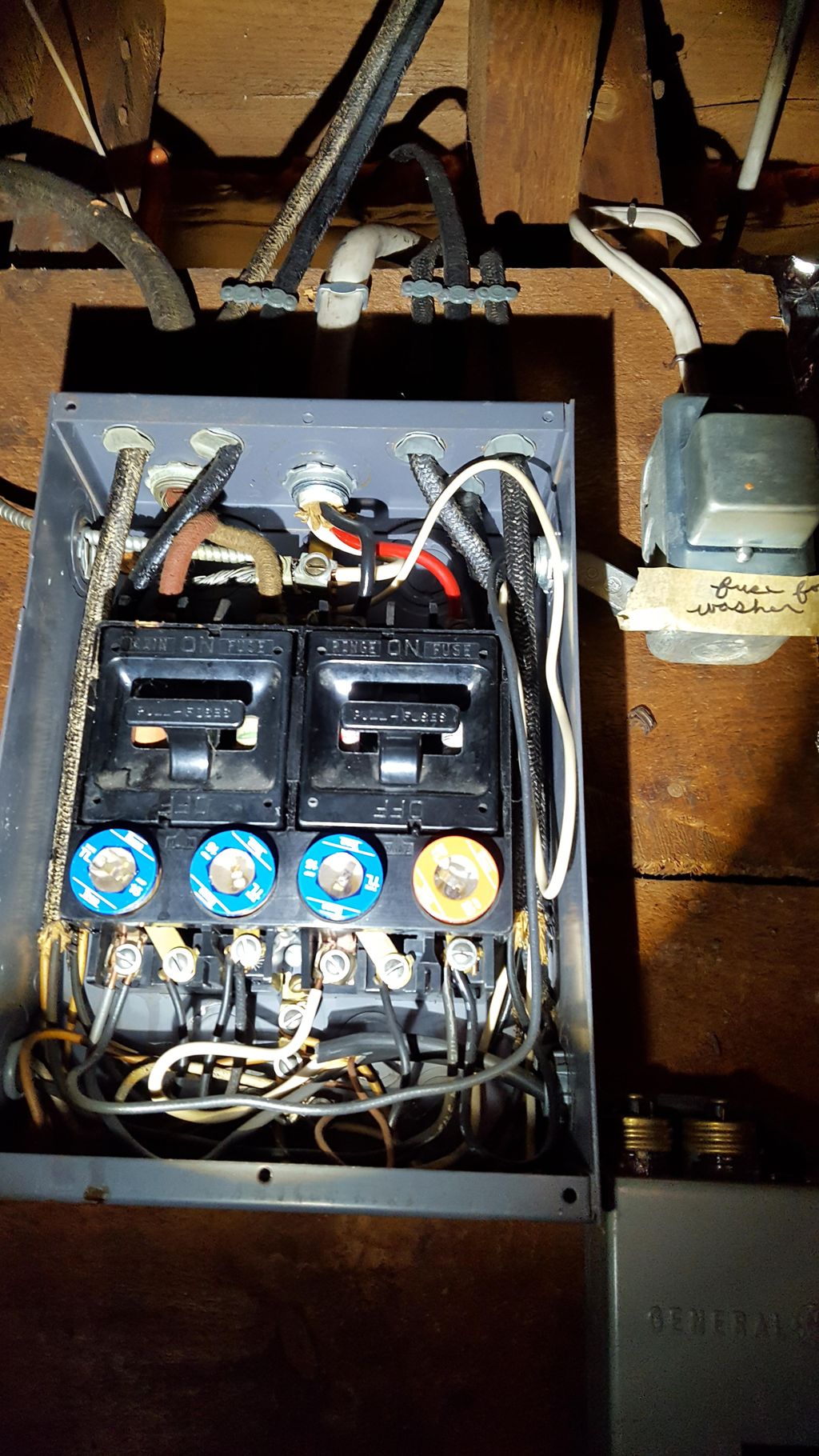 An older electric service panel with fuses reveale