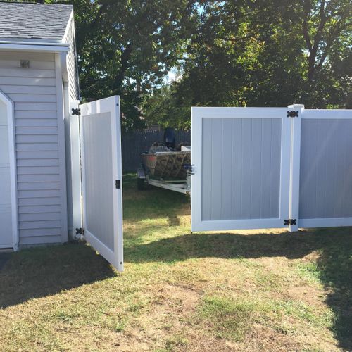 Grey and white vinyl fence with gate