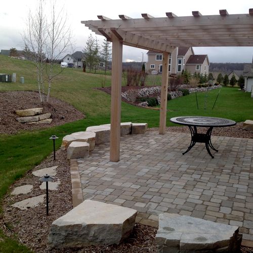 Purgola, patio, natural stone seatwall and outcrop